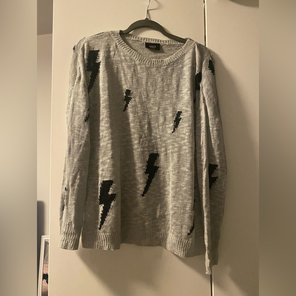 Grey sweater with lightening bolts
